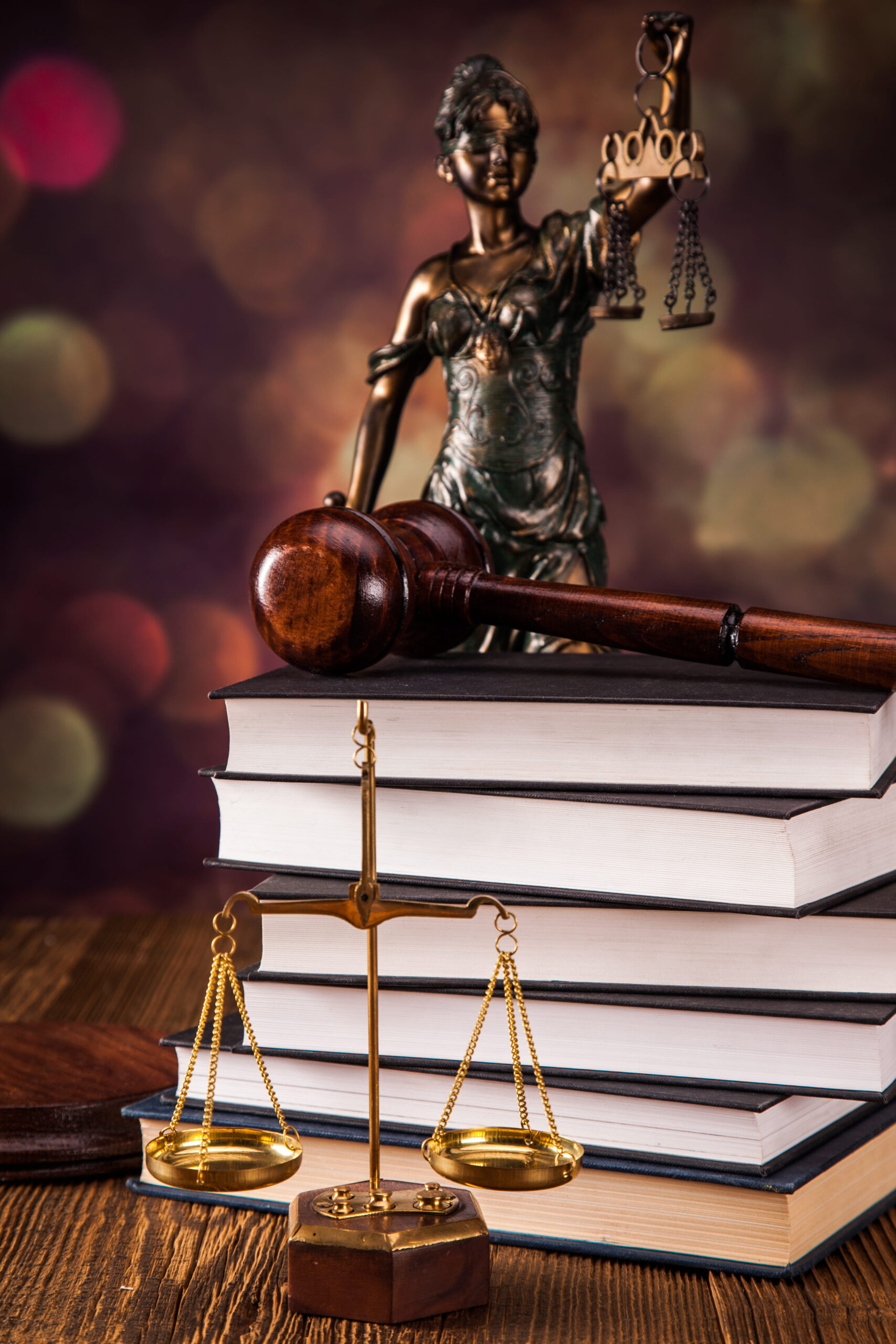 Santee criminal defense lawyer consulting client in office with scales of justice