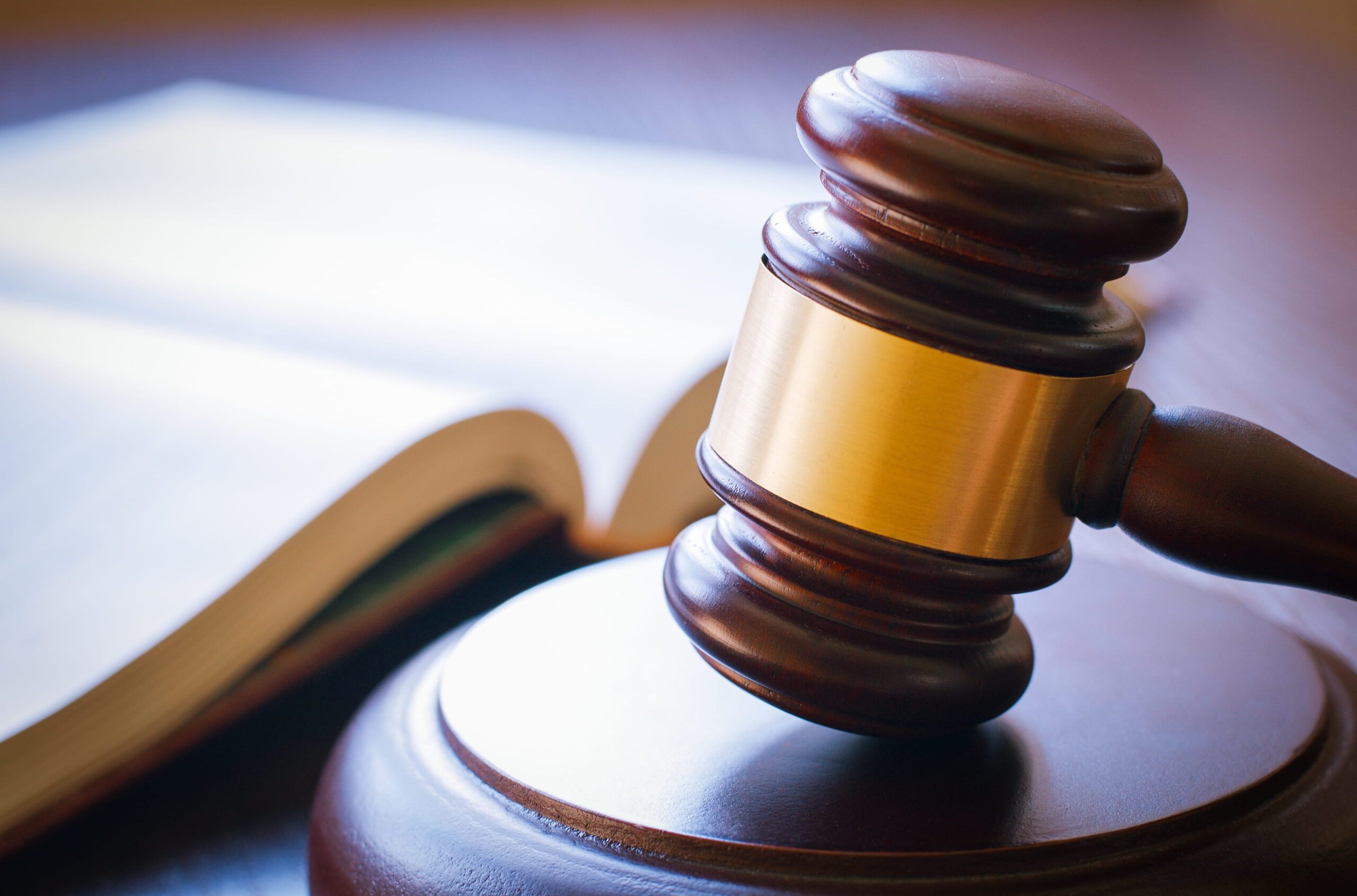 A wooden gavel on a sounding block representing the North County legal system and the advocacy of a San Marcos criminal defense attorney.