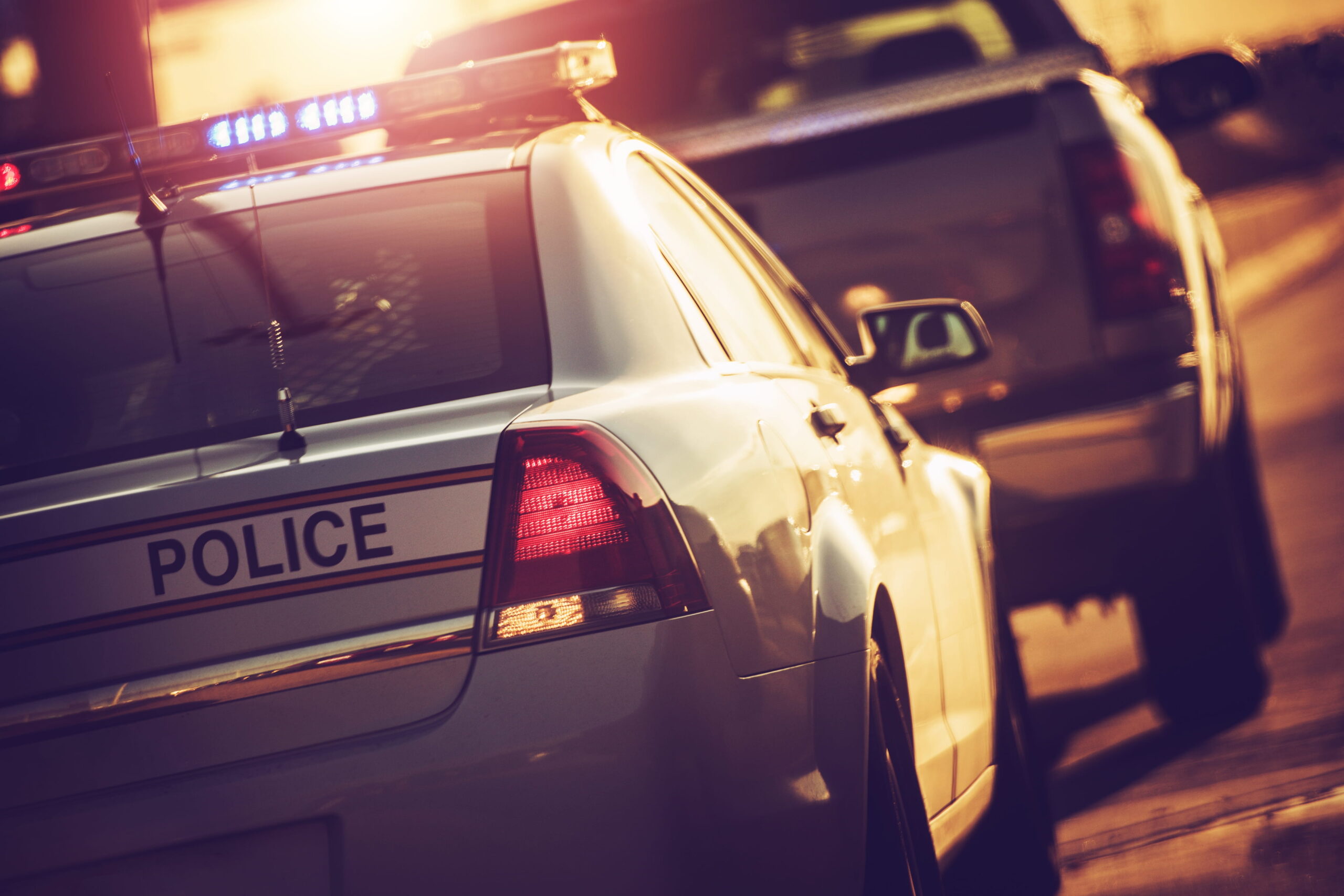 A National City police officer conducting a traffic stop on a California highway, highlighting the need for a criminal defense attorney.