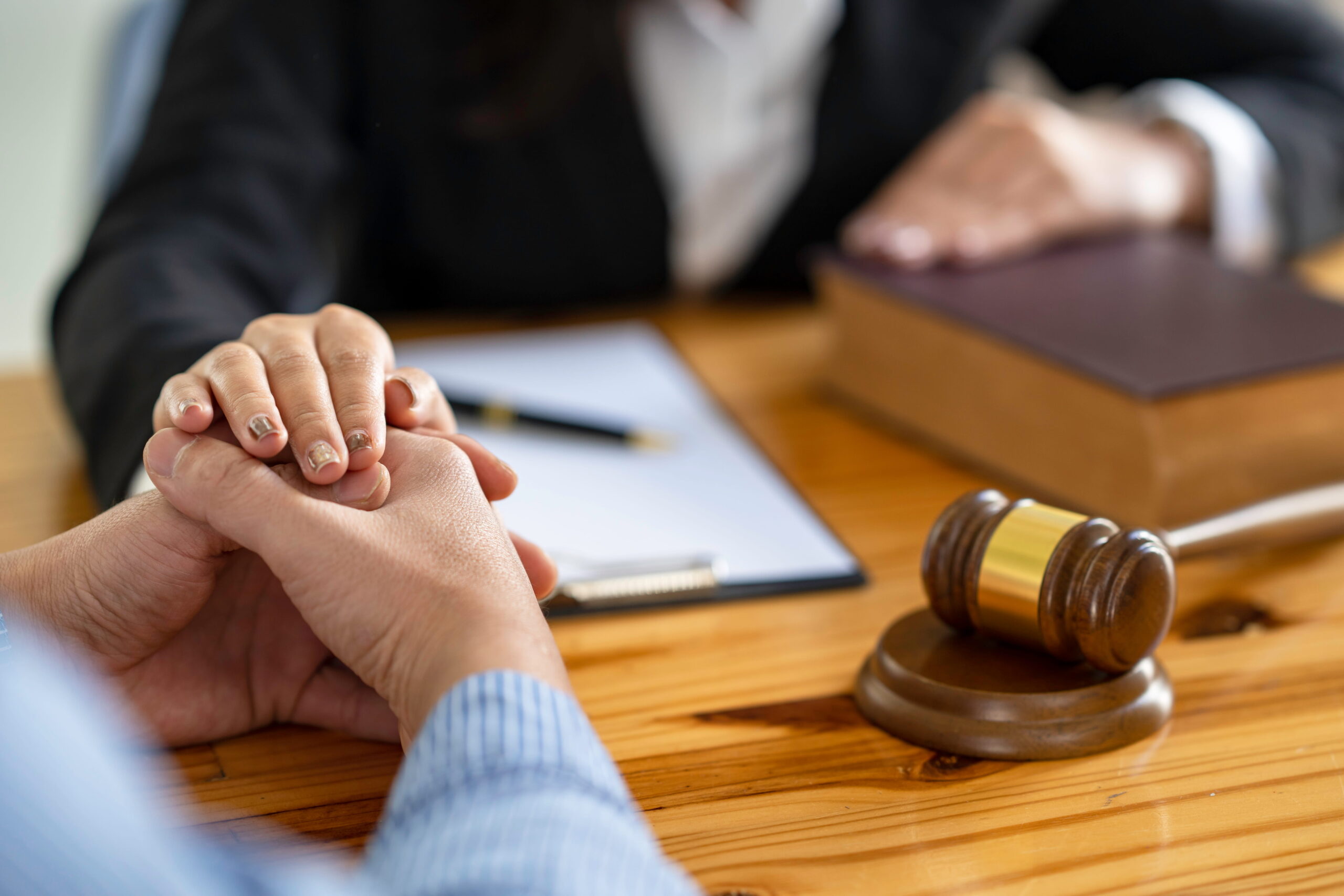 A Rancho Bernardo criminal defense attorney providing legal counsel and support to a client during a confidential office meeting.