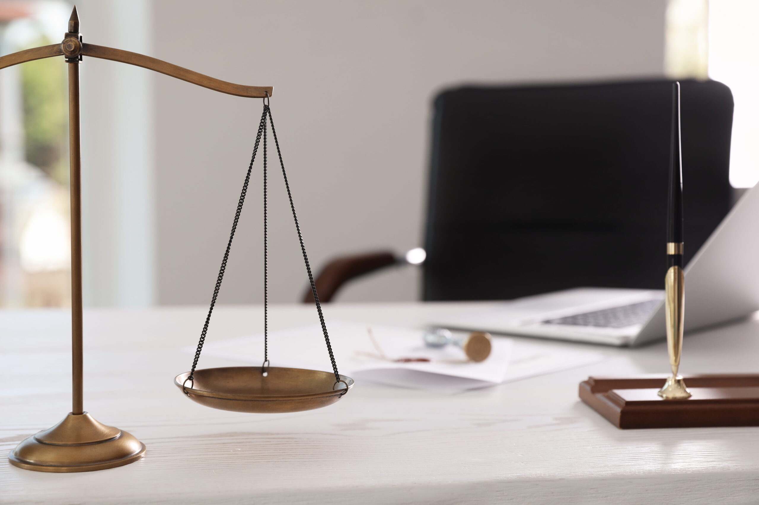 The Scales of Justice on a desk, representing the legal advocacy provided by a Solana Beach criminal defense attorney at the Vista Courthouse.
