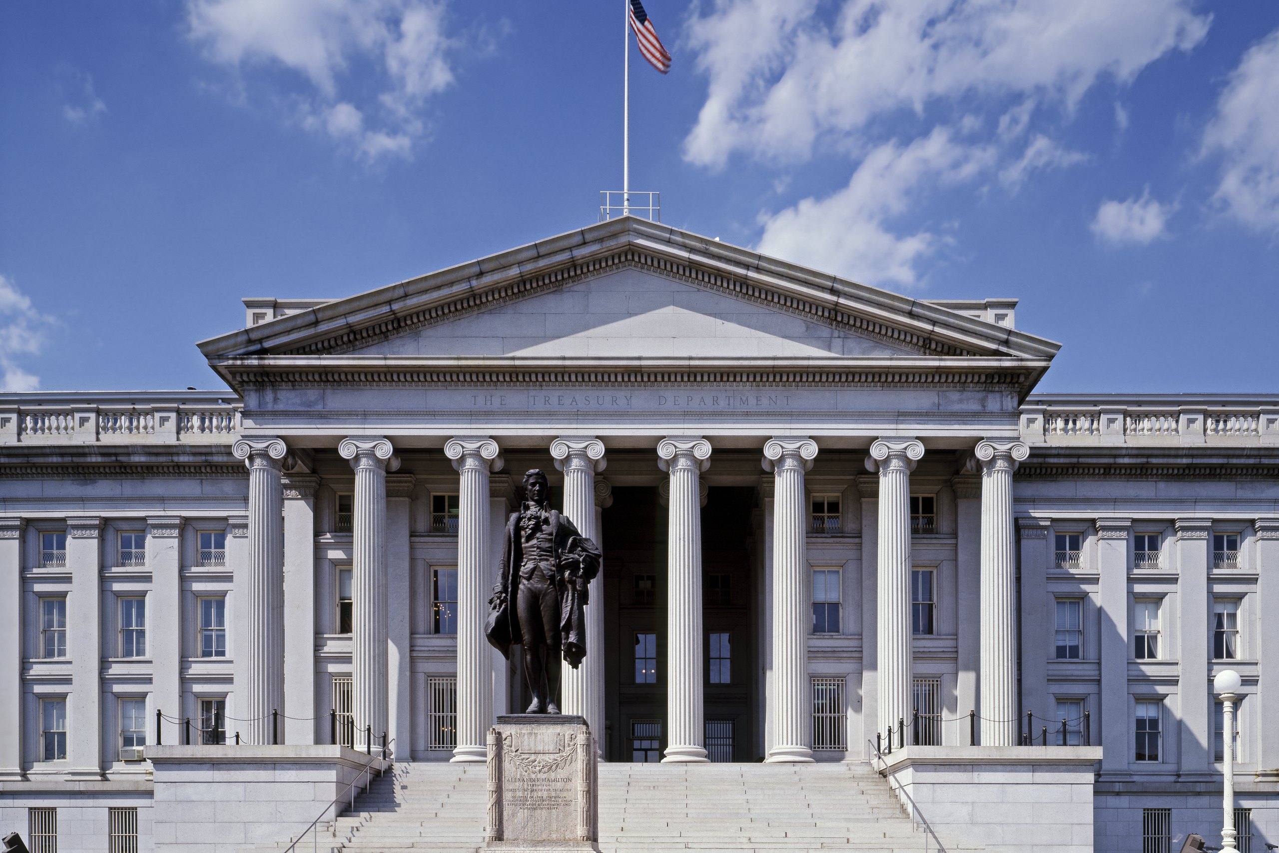 U.S. Treasury Department building on Pennsylvania Avenue in Washington, D.C., with the Alexander Hamilton statue in front