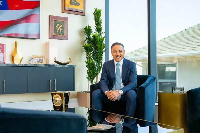 Attorney Vikas Bajaj seated in his San Diego office